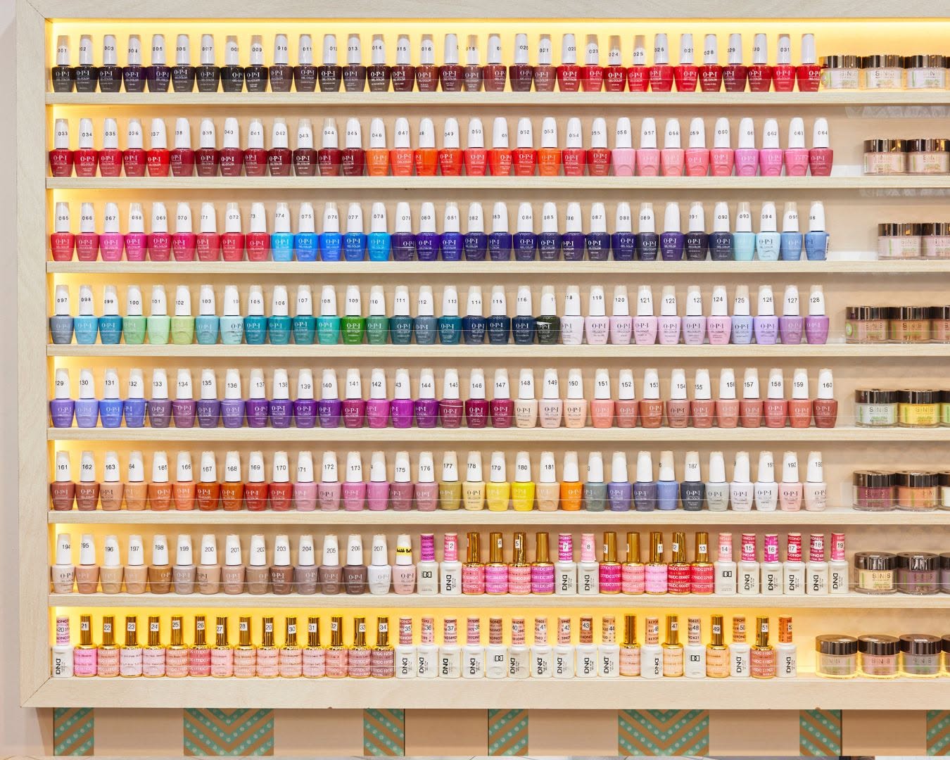 Wall of OPI gel colours and dipping powders at Lustre Nail Bar