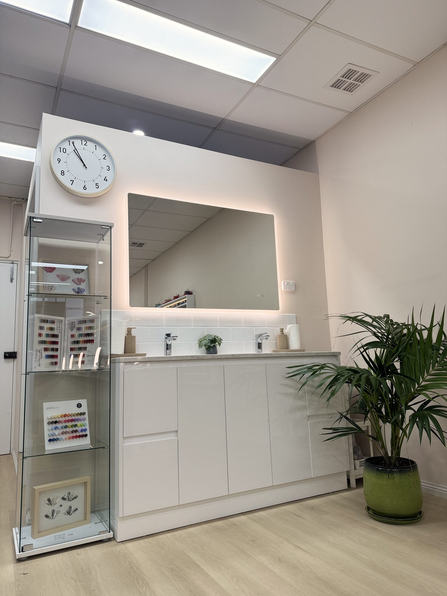 Mirror, cabinetry and plant inside Lustre Nail Bar Forest Hill